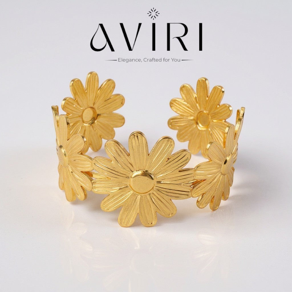 AVIRI gold-tone metal daisy flower cuff bracelet with an open design and adjustable fit.