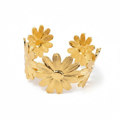 AVIRI gold-tone metal daisy flower cuff bracelet with an open adjustable design.