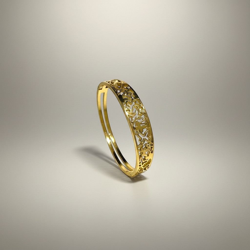 AVIRI gold-tone metal cuff bracelet with ornate filigree openwork design and polished finish.