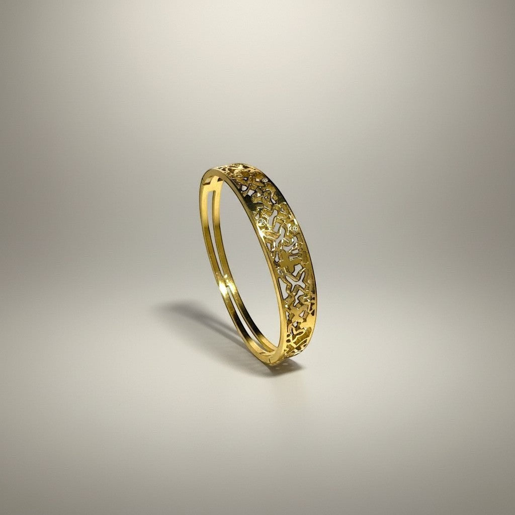 AVIRI gold-tone metal cuff bracelet with ornate filigree openwork design and polished finish.