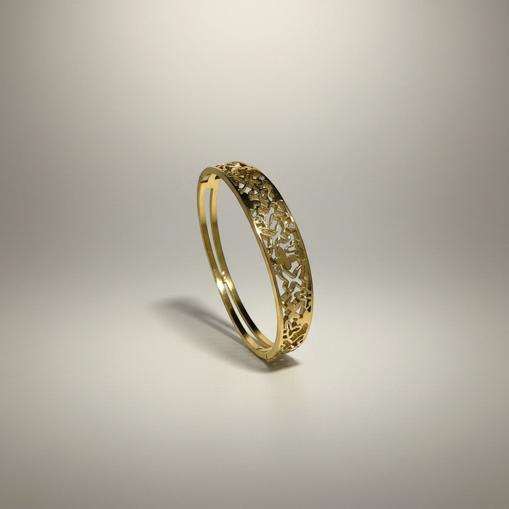 AVIRI gold-tone metal cuff bracelet with ornate filigree openwork design and polished finish.