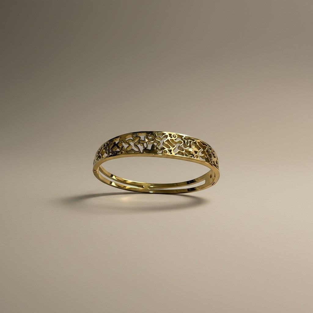 AVIRI gold-tone metal cuff bracelet with ornate filigree openwork design and polished finish.