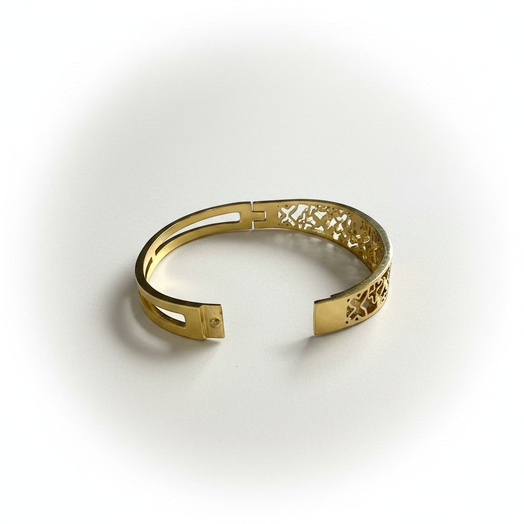 AVIRI gold-tone metal cuff bracelet with ornate filigree openwork design and polished finish.