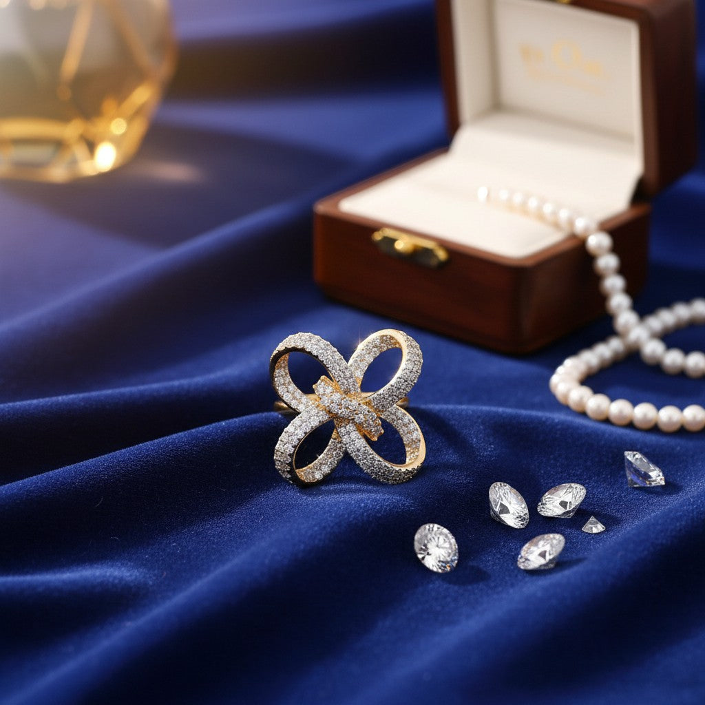 AVIRI gold polish statement ring with sparkling American Diamonds in a floral bow design.