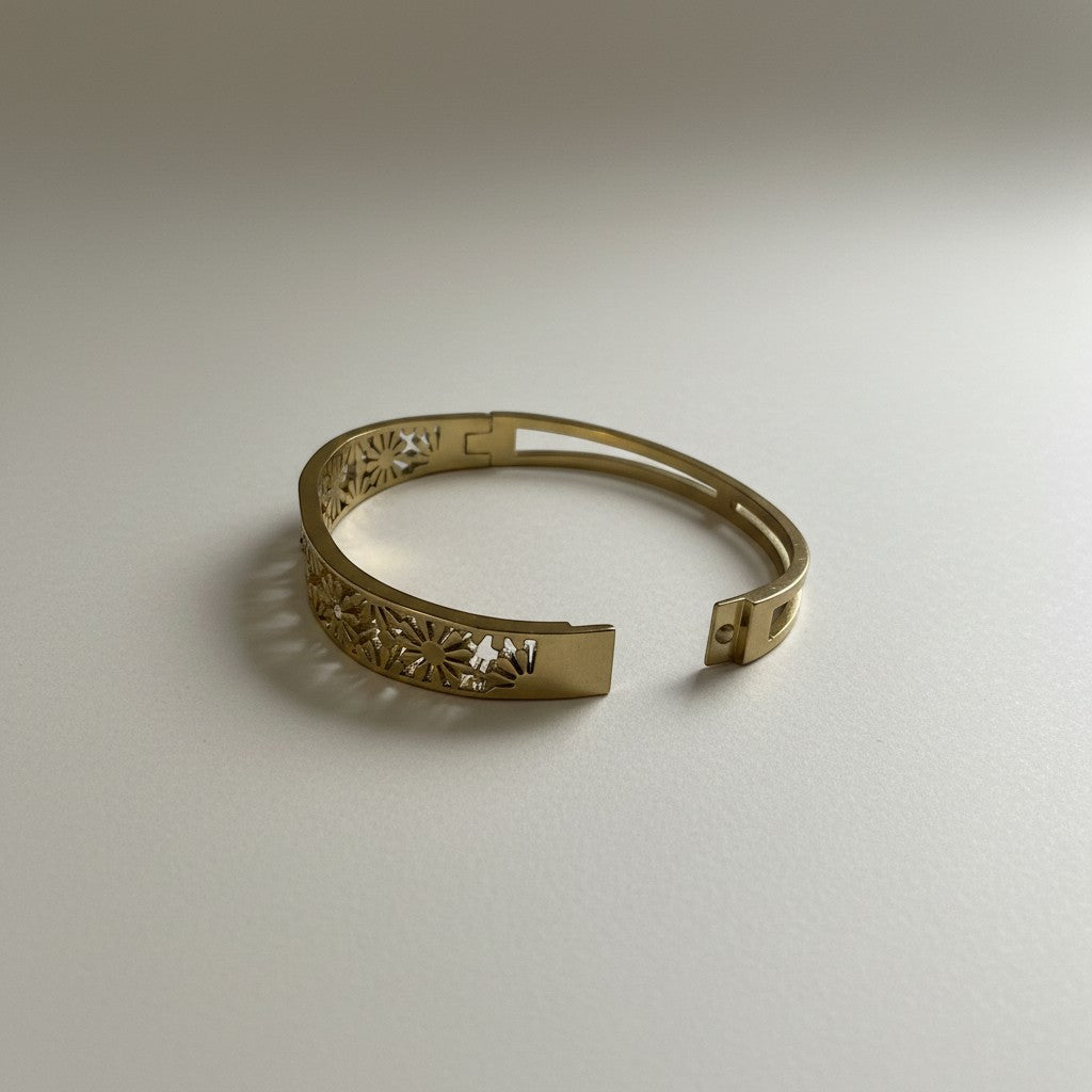 AVIRI gold-plated hinged bangle bracelet with intricate floral cut-out design and secure clasp.