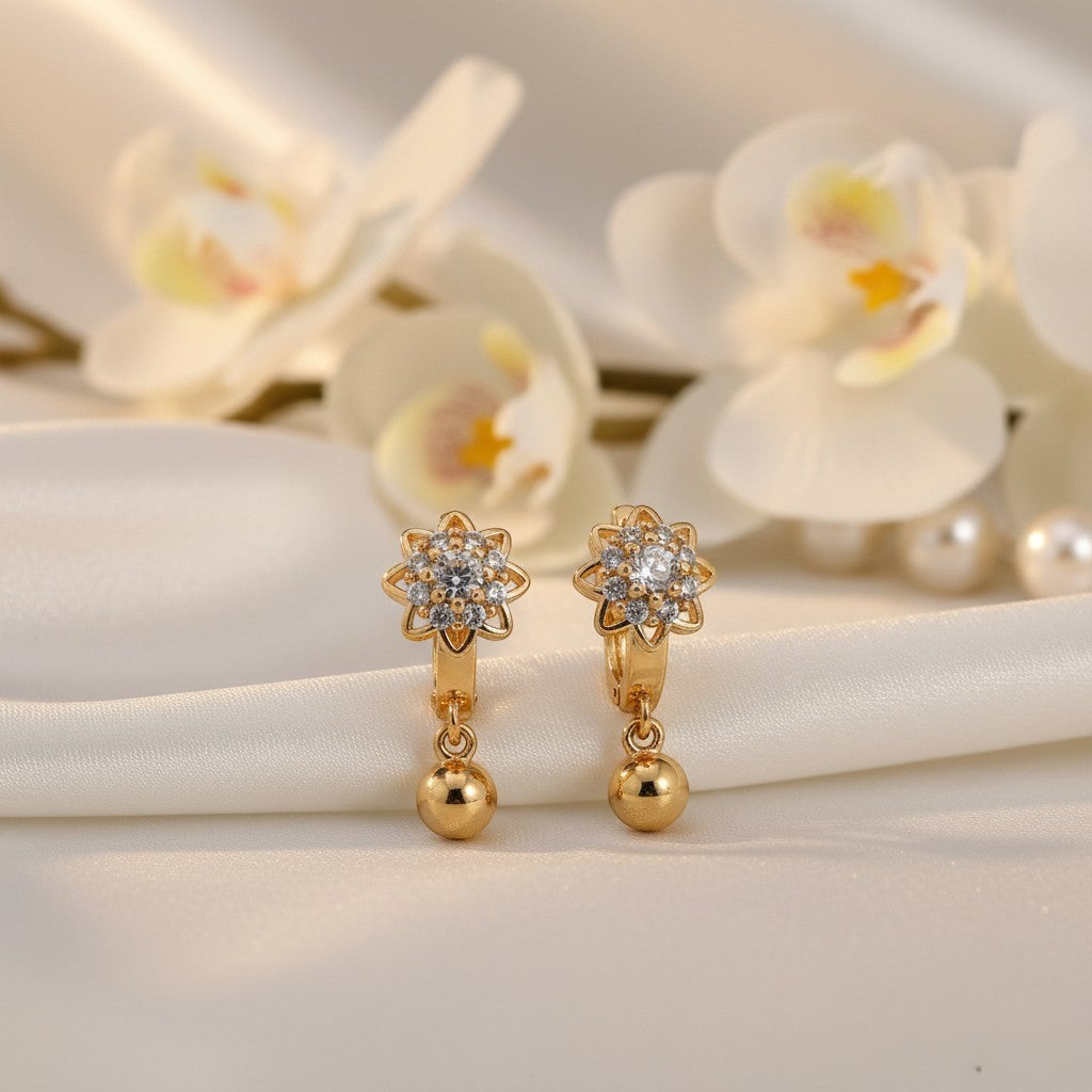 AVIRI gold-tone drop earrings with flower design, cubic zirconia, and dangling ball accent.