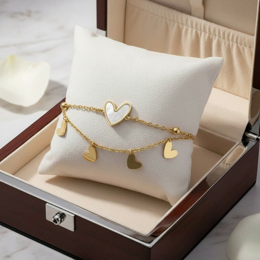 AVIRI double layer bracelet with gold heart charms and mother-of-pearl inlay heart, 18K gold plated.