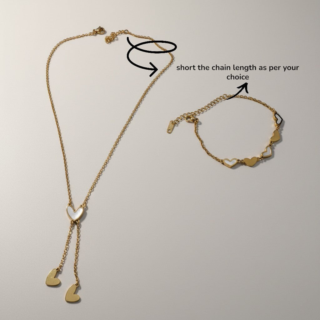 AVIRI gold-tone stainless steel necklace and bracelet set with heart charms. Necklace has a lariat design with a central heart pendant.