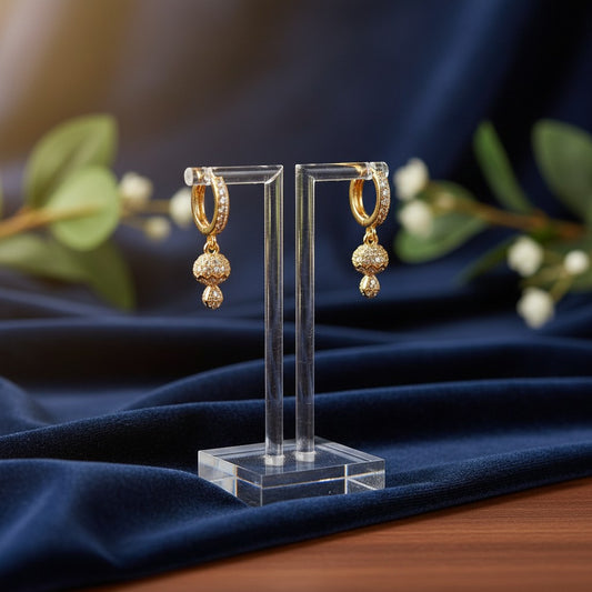 AVIRI gold-plated hoop earrings with cubic zirconia drop pendants. Textured bell charms add sparkle.