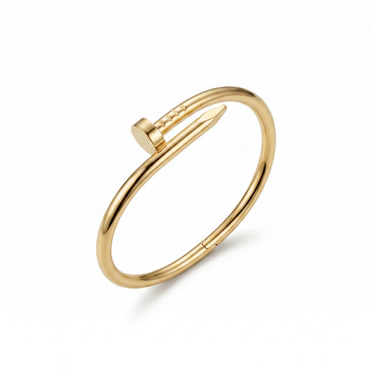 AVIRI gold-tone minimalist nail bangle bracelet with a polished finish and hinged closure on a white background.