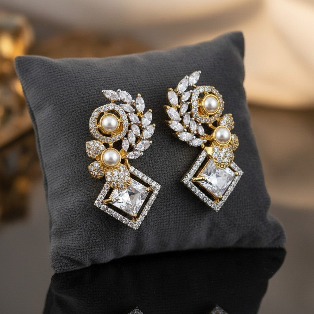 AVIRI elegant gold drop earrings with pearls, cubic zirconia, and leaf motifs. Geometric design with blue enamel accents.