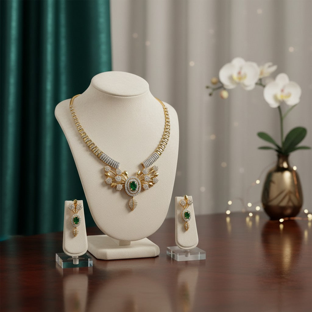 AVIRI gold-plated necklace and earring set with green cubic zirconia and leaf motifs.