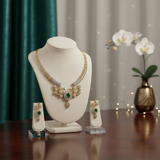 AVIRI gold-plated necklace and earring set with green cubic zirconia and leaf motifs.