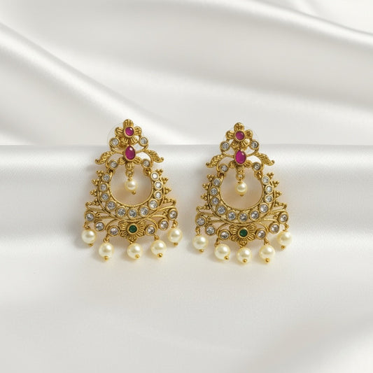 AVIRI gold-plated pearl drop chandbali earrings with ruby, emerald, and cubic zirconia accents.