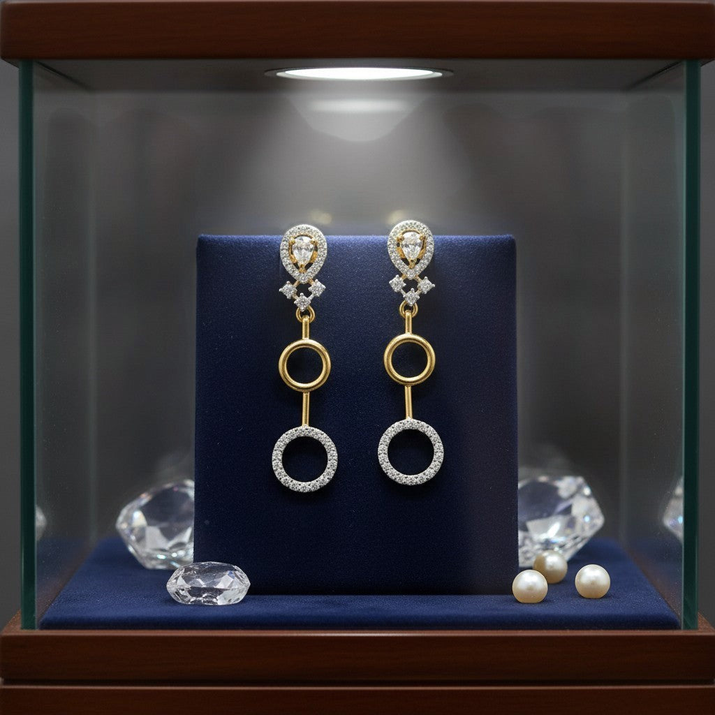 AVIRI gold and silver finish artificial AD drop earrings with circular design and clear stones.