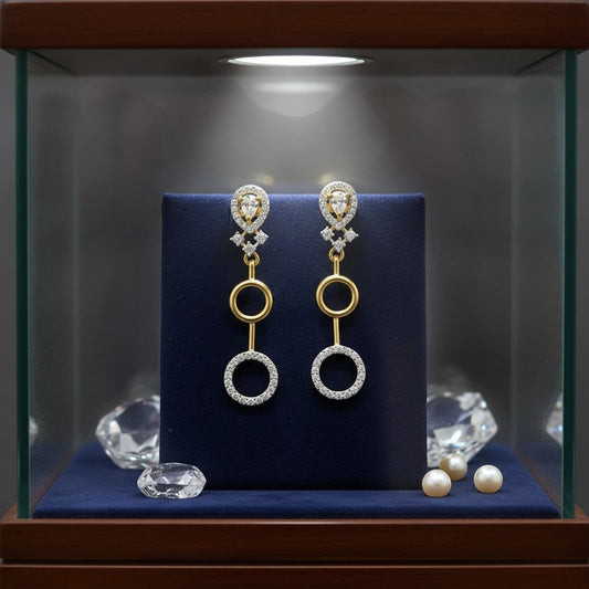 AVIRI gold and silver finish artificial AD drop earrings with circular design and clear stones.