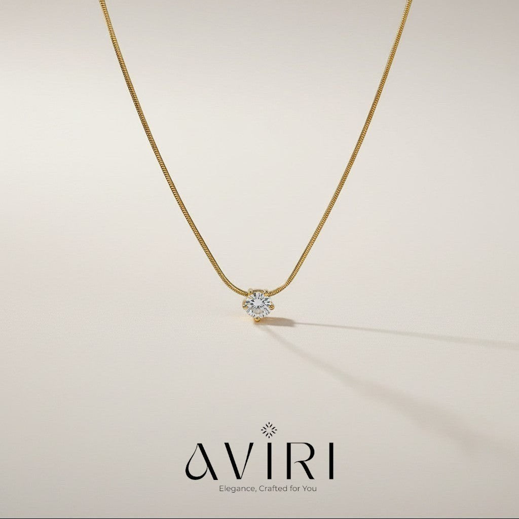 AVIRI gold snake chain necklace with a sparkling cubic zirconia solitaire pendant. Minimalist design.