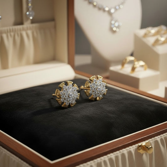 AVIRI gold-tone starburst stud earrings with clear cubic zirconia stones, perfect for adding sparkle.