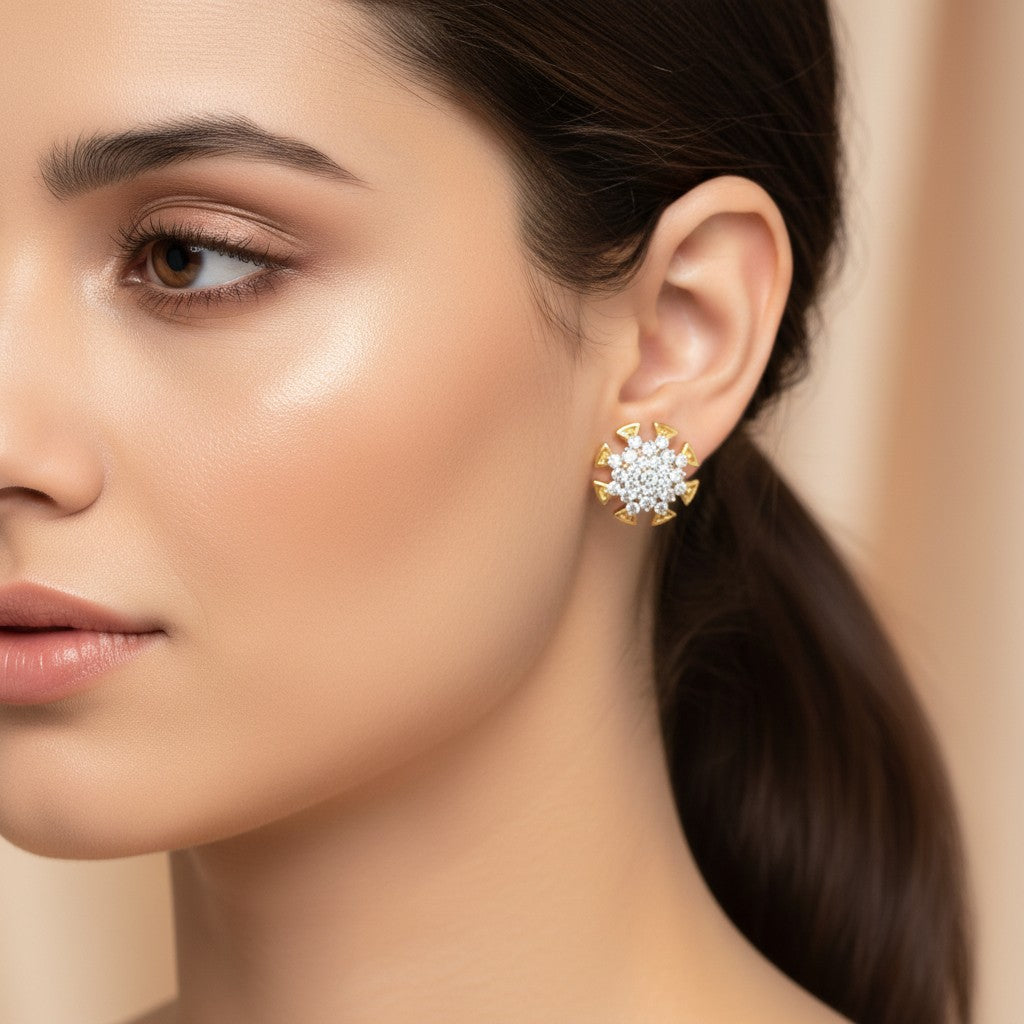 AVIRI gold-tone stud earrings with clear cubic zirconia in a starburst design. Elegant and sparkling.