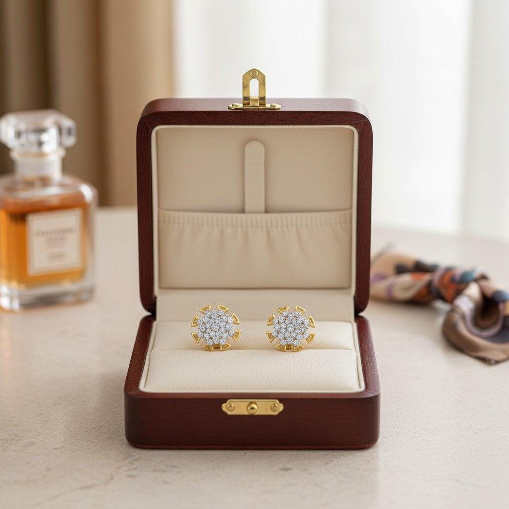 AVIRI gold-tone starburst stud earrings with clear cubic zirconia stones and butterfly backs.