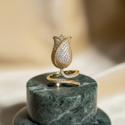 AVIRI gold-tone metal tulip ring with pave cubic zirconia and adjustable band. Floral statement jewelry.