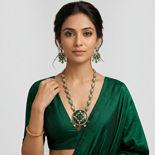 AVIRI traditional jewelry set with green enamel, white stones, and antique gold finish on a woman in a green saree.