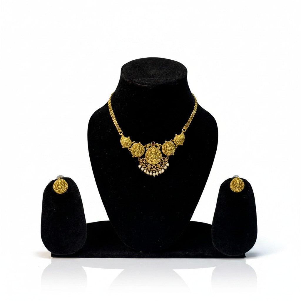 AVIRI gold-plated Indian necklace and earring set with deity motif, coin charms, and pearl drops.