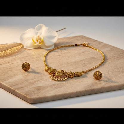 AVIRI gold-plated Indian necklace and earring set with deity motif, pearl drops, and intricate detailing.