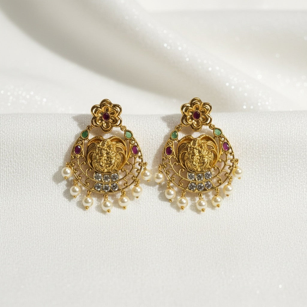AVIRI gold-plated Lakshmi motif earrings with ruby, emerald, pearl, and clear stones. Traditional Indian design.