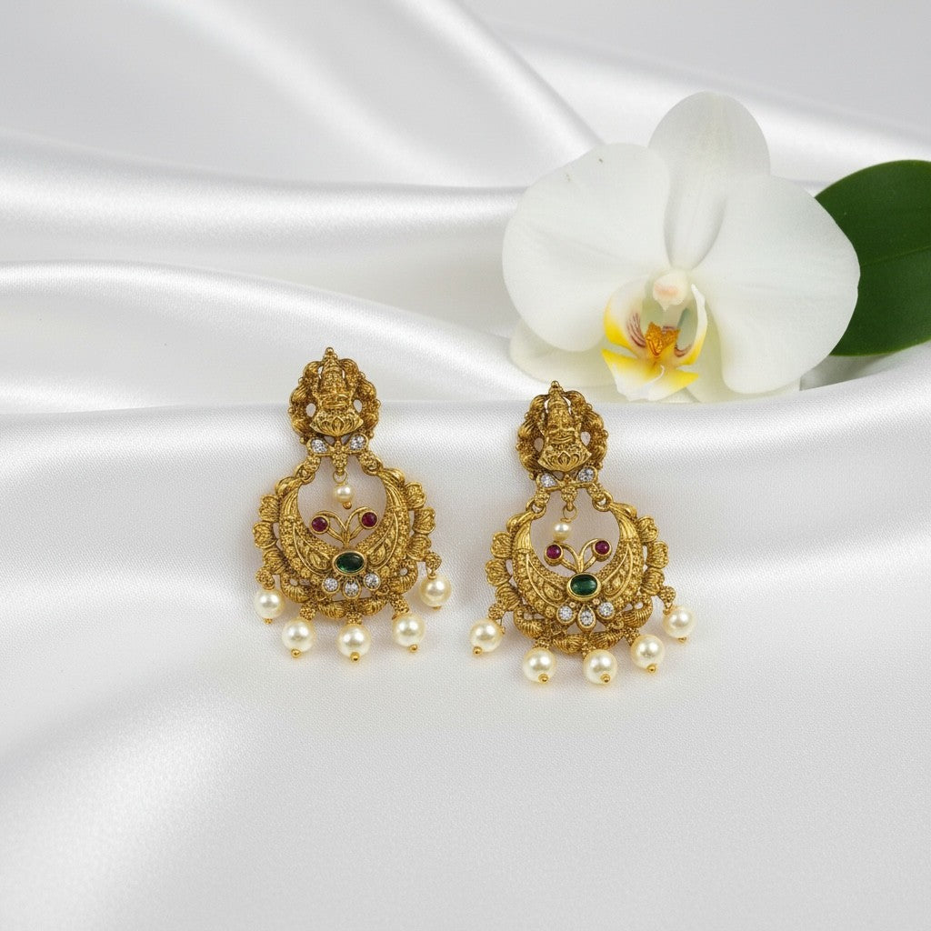AVIRI antique gold-plated Lakshmi temple earrings with pearls, ruby, emerald, and cubic zirconia stones.