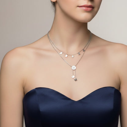 AVIRI silver layered necklace with butterfly charms and a central circular pendant. Delicate chains add whimsical elegance.