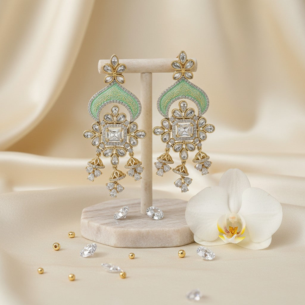 AVIRI ornate gold-tone chandelier earrings with green enamel, cubic zirconia, and floral motifs.