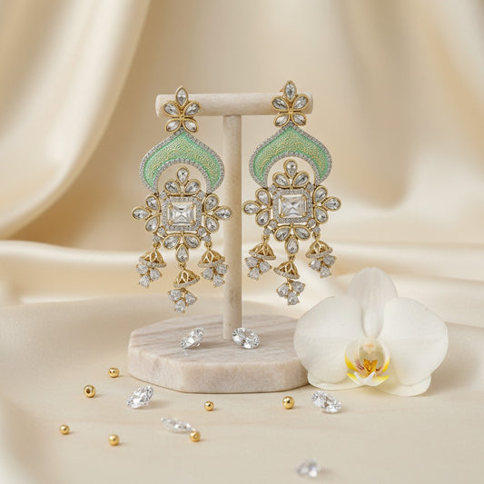 AVIRI ornate gold-tone chandelier earrings with green enamel, cubic zirconia, and floral motifs.