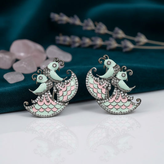 AVIRI peacock design AD earrings with pastel mint and pink enamel, sparkling diamonds, and silver black polish.