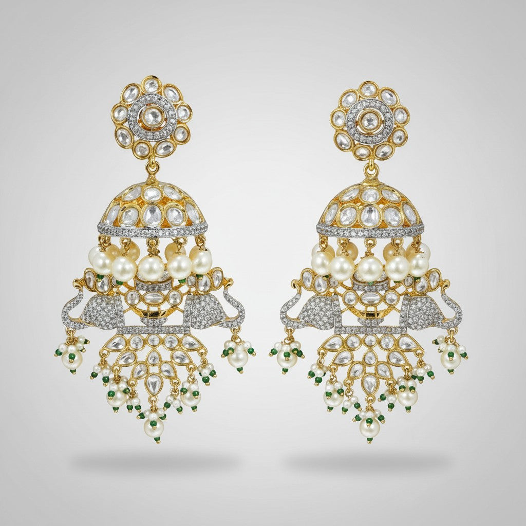 AVIRI gold-plated jhumka earrings with peacock motifs, white stones, pearls, and green beads.