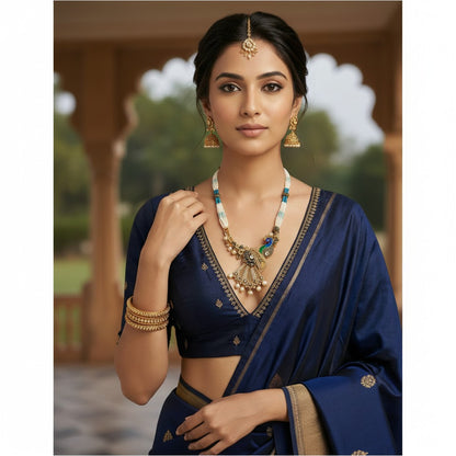 AVIRI peacock-inspired necklace and earrings set with white and blue beads, gold-tone metal, shimmering stones, and pearls.