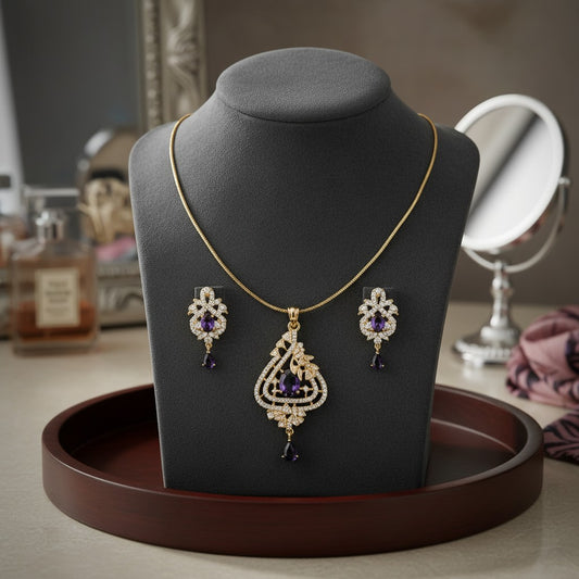 AVIRI elegant gold-tone pendant necklace and earring set with purple teardrop cubic zirconia stones and clear accents.