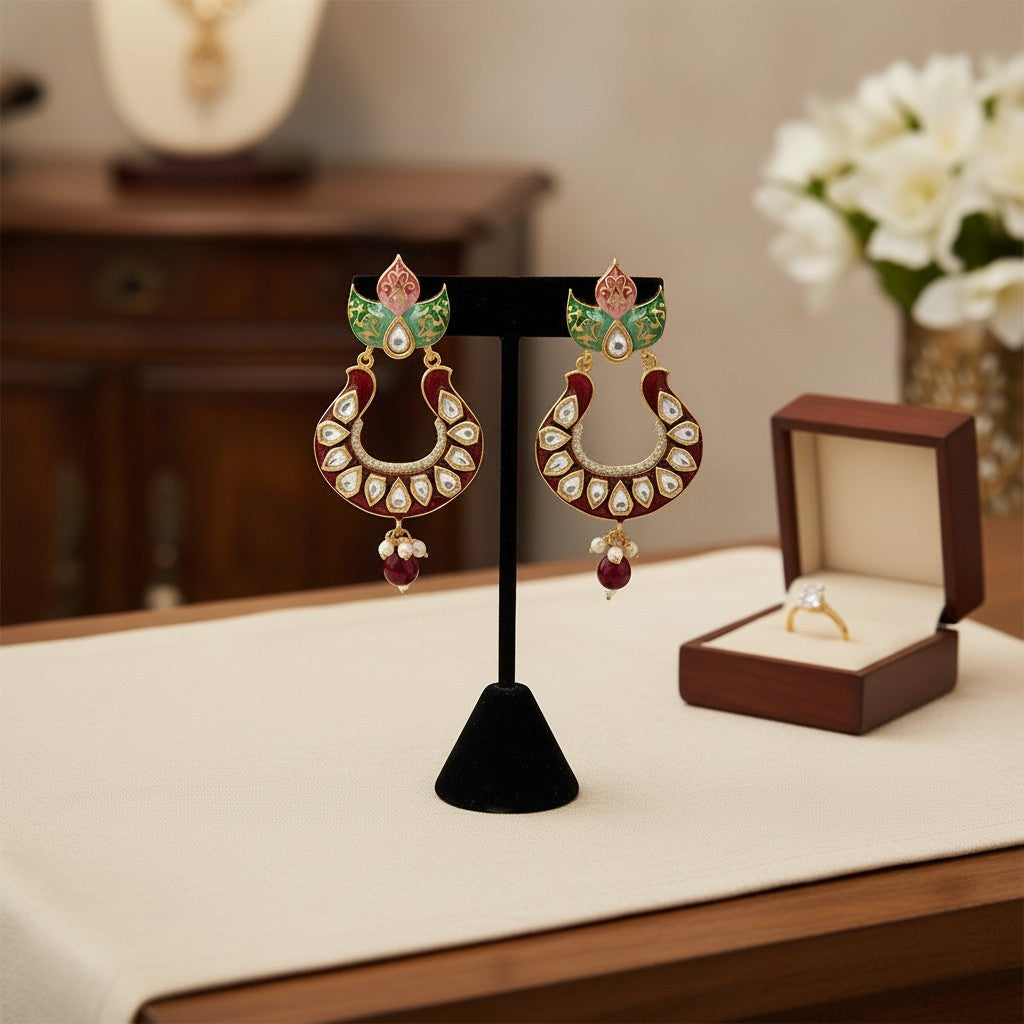 AVIRI red enamel Kundan Chandbali earrings with floral detailing, white stones, pearl and ruby drops.