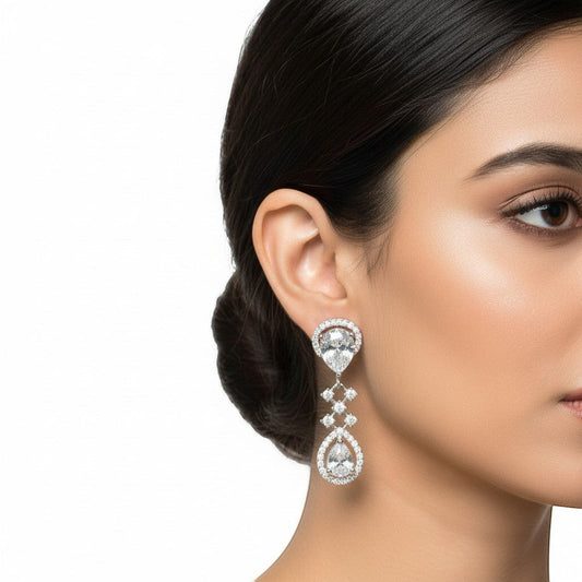 AVIRI silver polished drop earrings with teardrop American diamonds, perfect for special occasions.