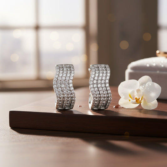 AVIRI silver polished hoop earrings with wavy design and micro AD stone setting.