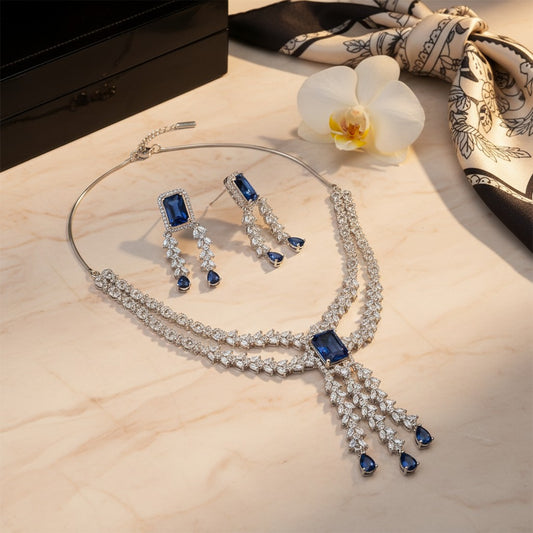 AVIRI statement necklace and drop earrings set with silver-tone metal, blue rectangular and teardrop crystals.