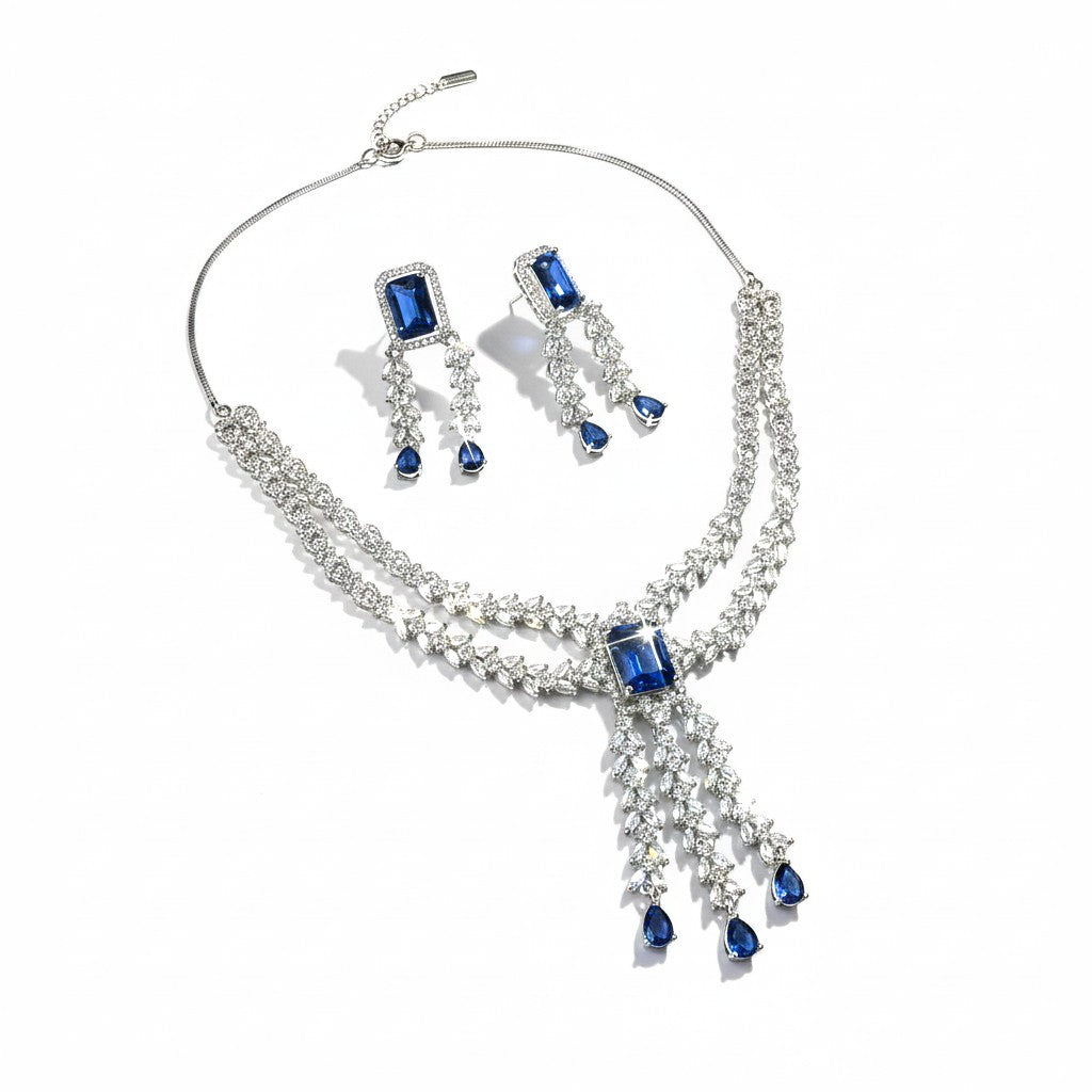 AVIRI statement necklace and drop earrings set with deep blue rectangular and teardrop crystals, silver-tone metal.