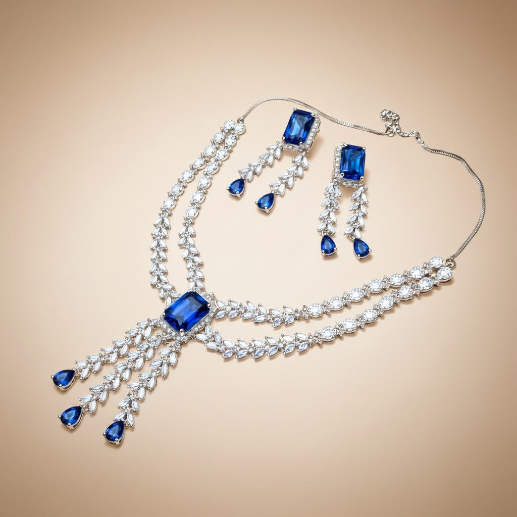 AVIRI statement necklace and drop earrings set with deep blue rectangular and teardrop crystals, silver-tone metal.