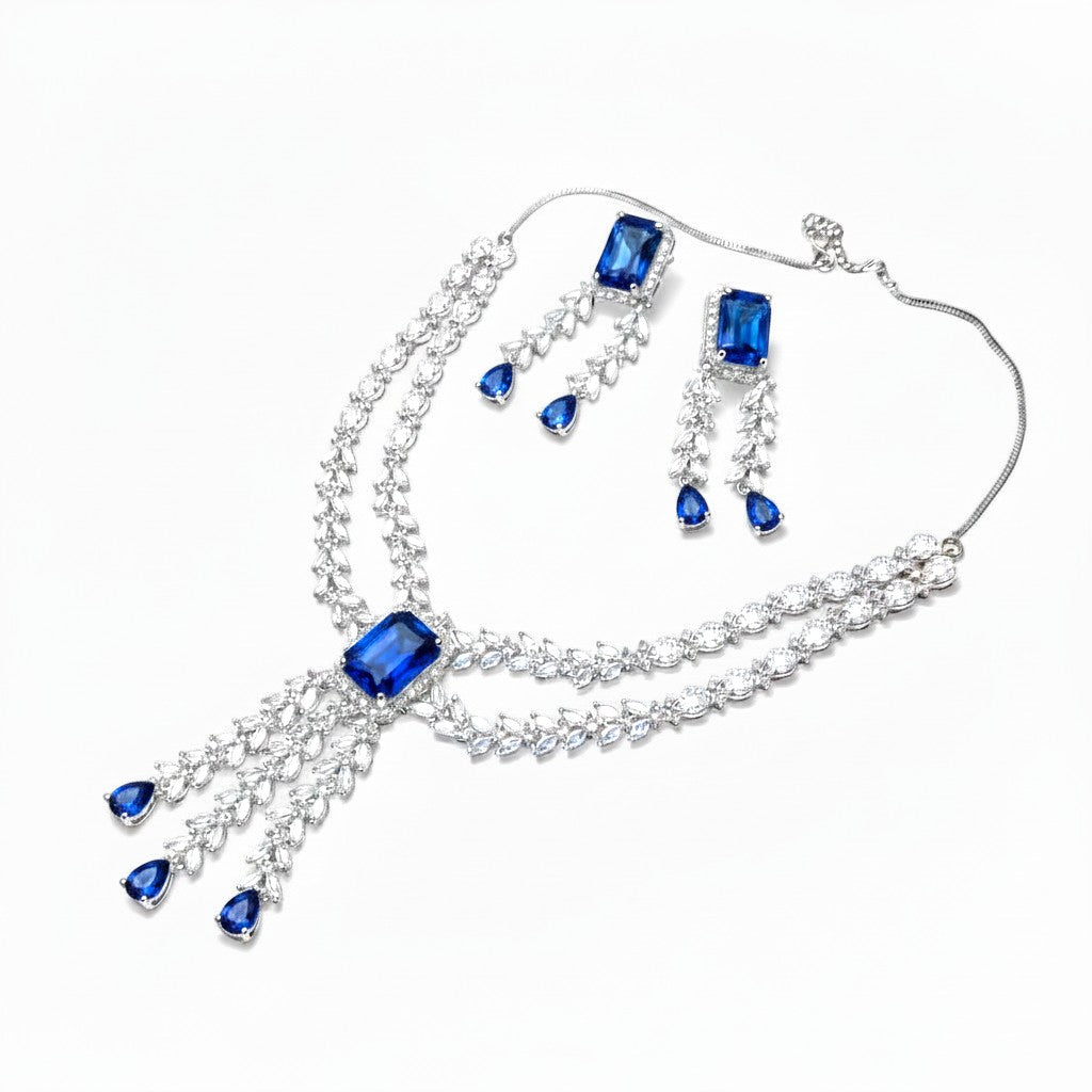 AVIRI statement necklace and earring set with deep blue rectangular and teardrop crystals, silver-tone metal.