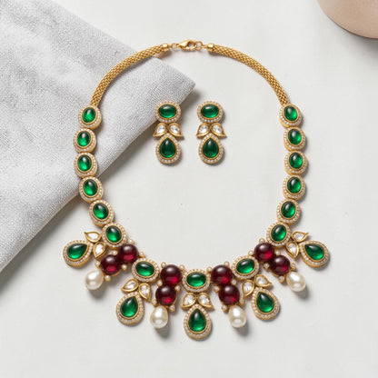 AVIRI traditional necklace and earring set with green and red cabochon stones, faux pearls, and gold-tone metalwork.