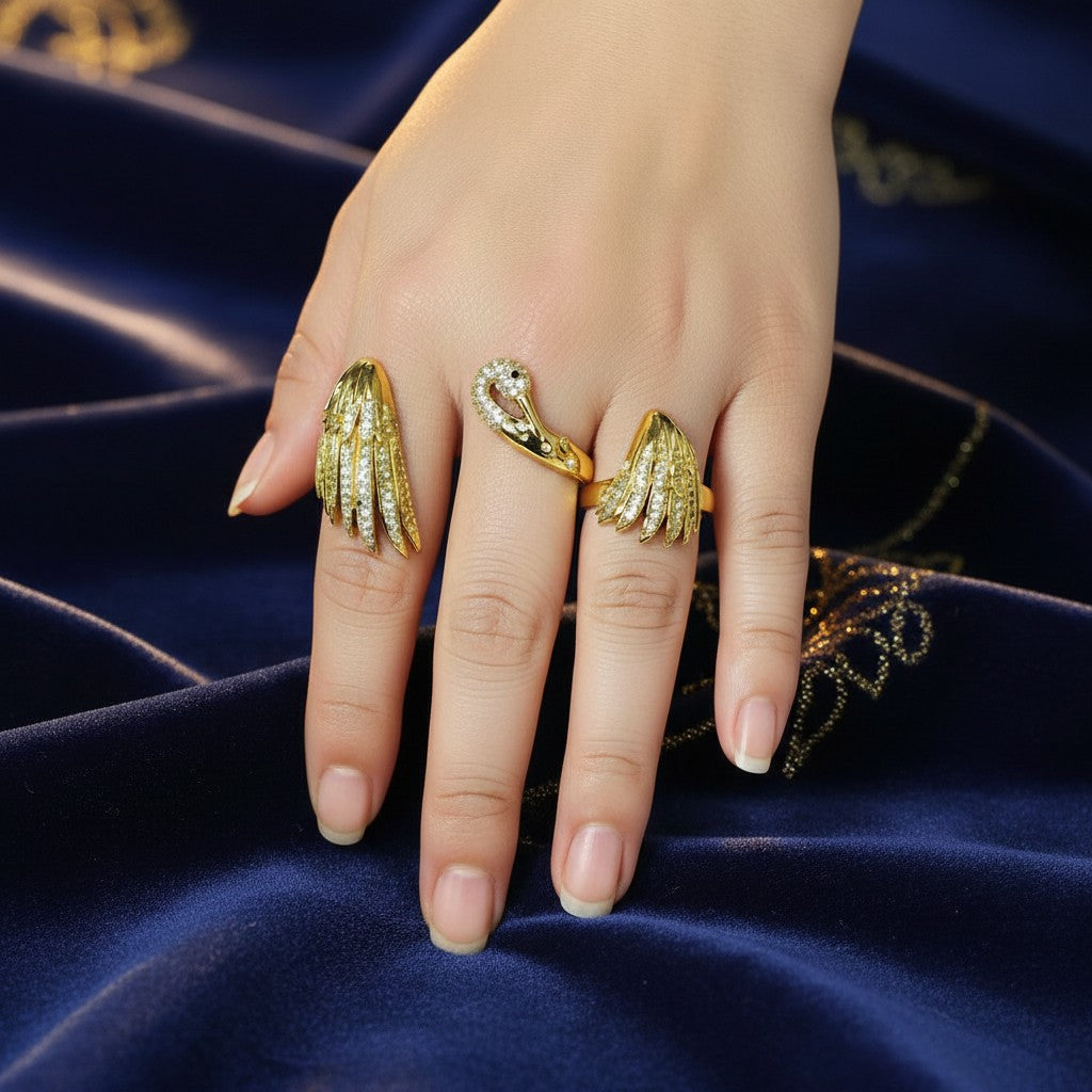 AVIRI gold-tone metal swan and wings ring set with clear crystals. Features a detailed swan head and feathered wings.