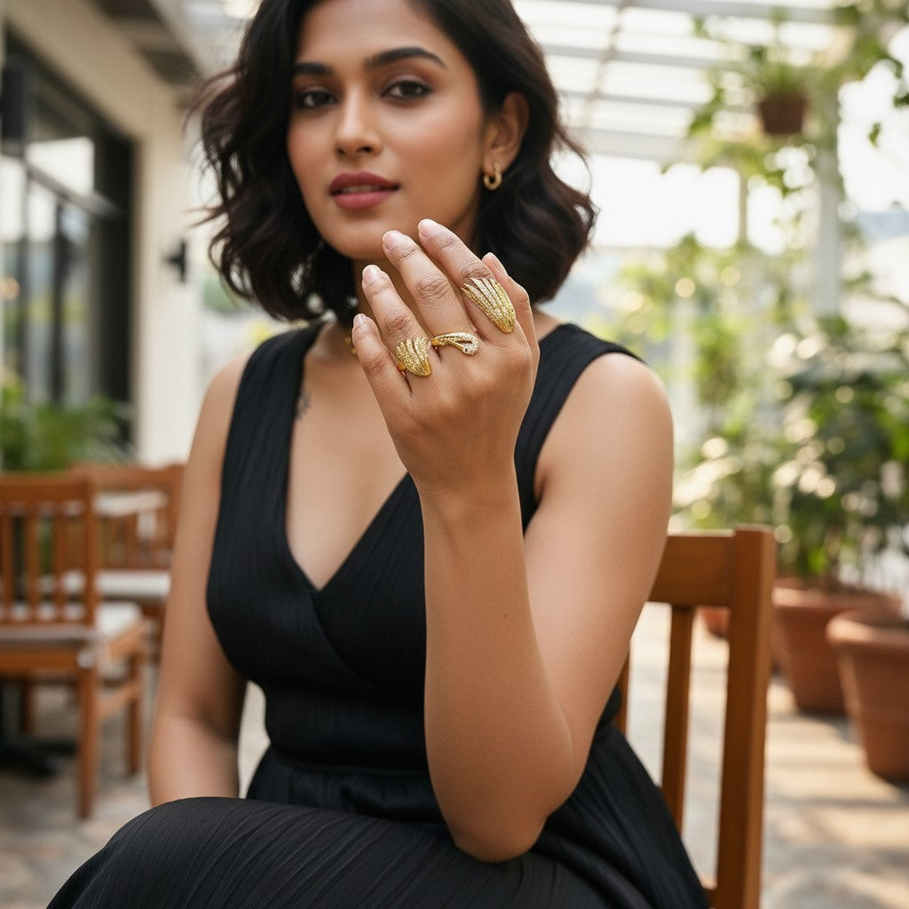 AVIRI gold-tone metal swan and wings ring set with clear crystals on a hand.