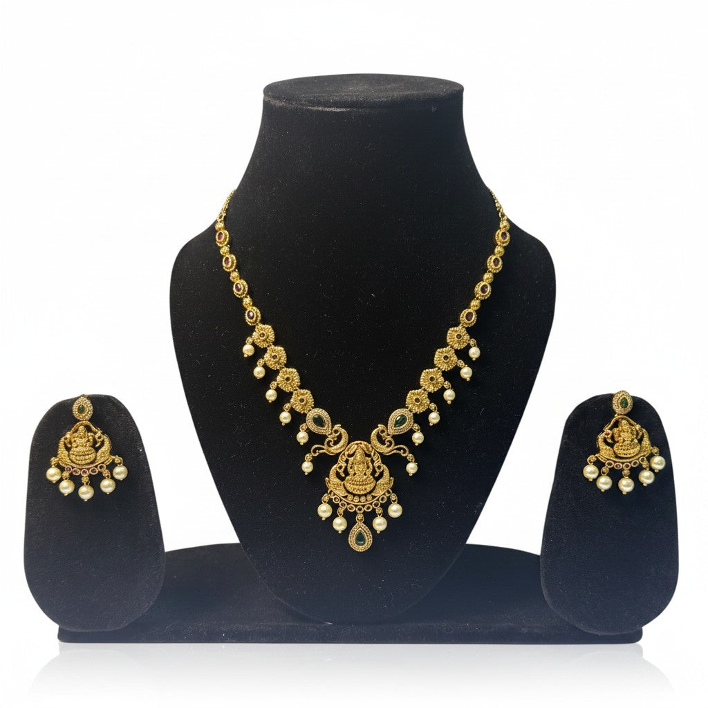 AVIRI traditional gold plated necklace and earring set with green and red stones and pearls. Intricate carvings.