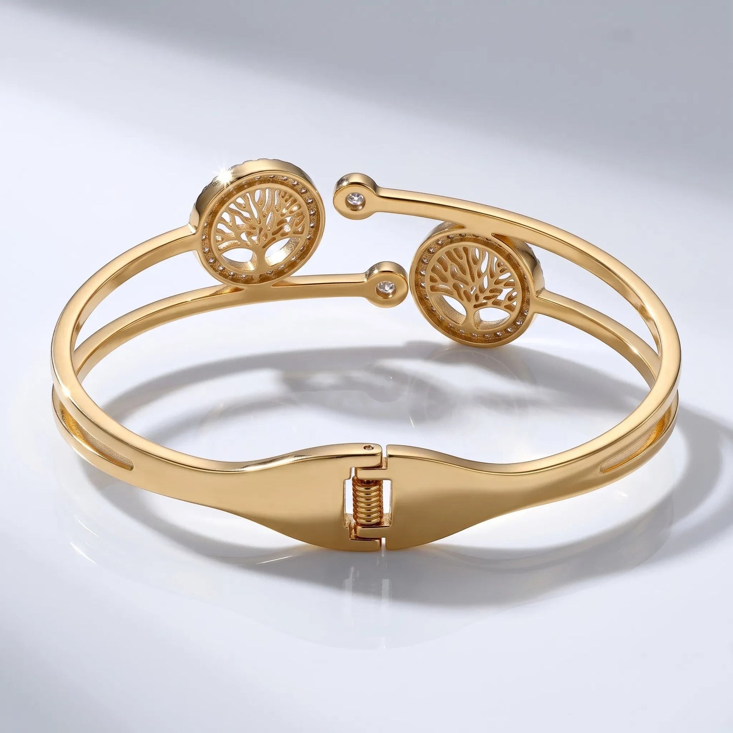 AVIRI Tree of Life hinged bracelet in 18K gold-plated metal with cubic zirconia accents and a secure clasp.